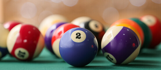 Colorful billiard balls on table, closeup