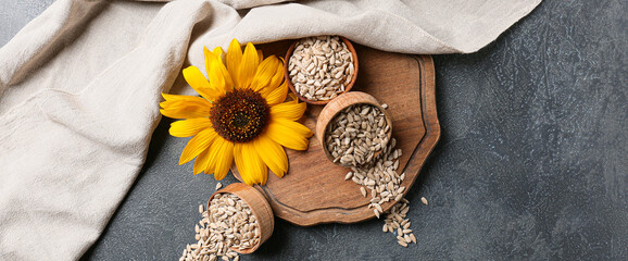 Composition with peeled sunflower seeds on grey background