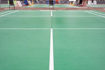 empty green used badminton court background is ready for playing badminton in competition or...