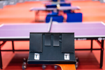 A tennis table black scoreboard is placed next to the table tennis table for referee count the...