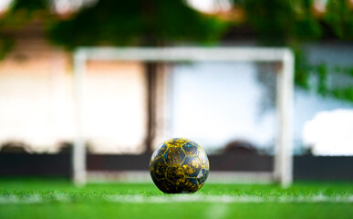 a ball in the center of the field in front of soccer goal for penalty kick.