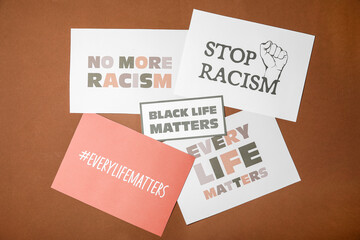 Different placards on color background. Concept of racism