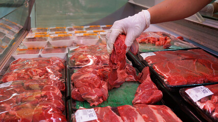 close-up of butcher meat, female chef in a supermarket store with meat and fresh vegetables, fresh pork at supermarket
meat shop, beef, pork, sausage, salami and other products.