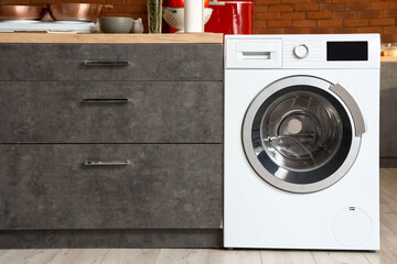 Modern washing machine and counter in kitchen