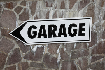 arrow with garage text indicating the direction for parking cars