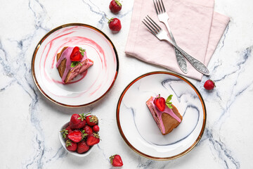 Composition with plates of tasty strawberry cake and berries on light background