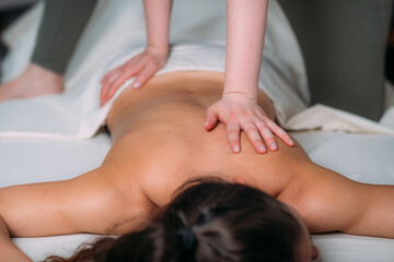 Obraz na płótnie Canvas Back massage in a massage salon, woman having a relaxing back massage.