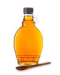 Bottle of maple syrup and wooden spoon on white background
