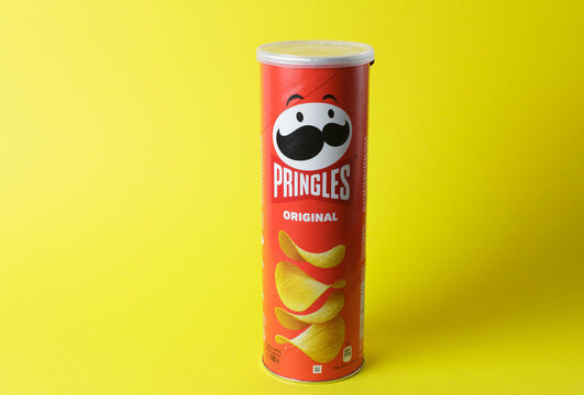 Zaporizhzhia, Ukraine - May 28, 2022: PRINGLES original potato chips in a package on a yellow paper background