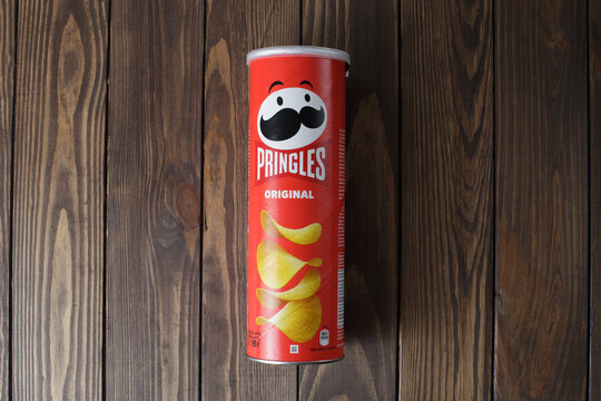 Zaporizhzhia, Ukraine - May 28, 2022: PRINGLES original potato chips in a package on a wooden background