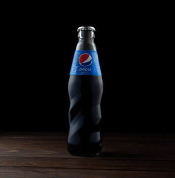 Zaporozhye Ukraine - May 11, 2022: Pepsi Glass Bottle With Highlights On A Wooden Background.