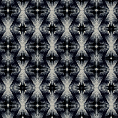 Seamless monochrome ethnic ikat pattern. Light gray ornament on a black background.