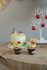 Baking cakes and cupcakes decorated in forest style, grass, mushrooms and a little princess