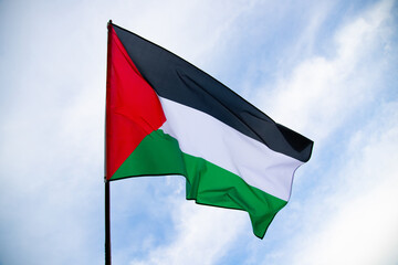 Close up view of the flag of Palestine waving in the wind - obrazy, fototapety, plakaty
