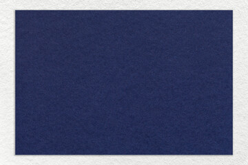 Texture of craft navy blue color paper background with white border, macro. Vintage dense kraft denim cardboard