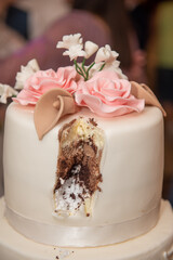 The bride's cake with white and pink roses at the wedding