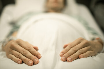 Unrecognizable pregnant woman lying in hospital bed 