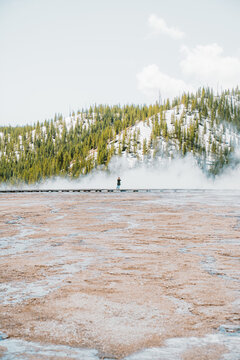 Woman photographing thermal pools in Yellowstone national park