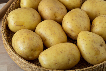 Raw potato in a wicker bowl