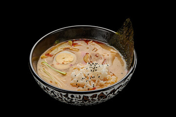 Kimchi Tige soup in a deep dish on a black isolated background