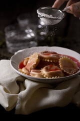 Dumpling with sugar, on a dark background, food photography.