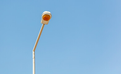 Street lamp against the blue sky.