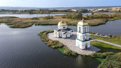 Fototapeta na wymiar Top view of the restored church on the island in the village of Gusintsy 