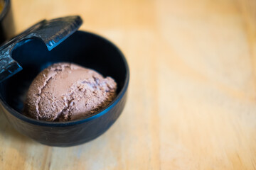 Delicious fresh grated chocolate in black bowl