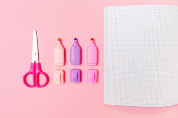 Back to school. Composition with opened copybook, markers and scissors on pink background. Flat lay. Mock up