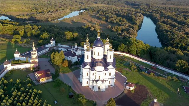Orbital aerial footage of Svensky Uspensky Monastery on sunny summer evening. Suponevo, Bryansk Oblast, Russia.