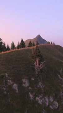 Aerial footage of the Swiss alps slopes and river during sunset