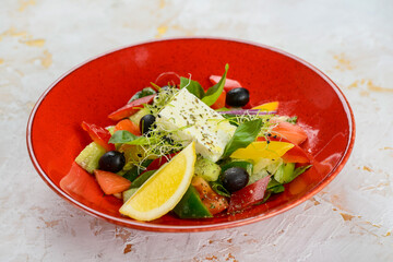 Greek salad in a red plate
