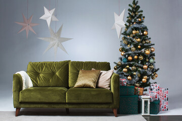 New Year greeting card, green sofa and Christmas tree decorated for the fest