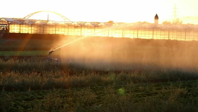 Tractor beside agricultural irrigation system is needed due to hot summer drought caused by climate change threatens agriculture and farming industry with dry weather and no rainfall increase prices