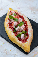 oriental flatbread with cheese and strawberries and mint leaves vertical macro photo
