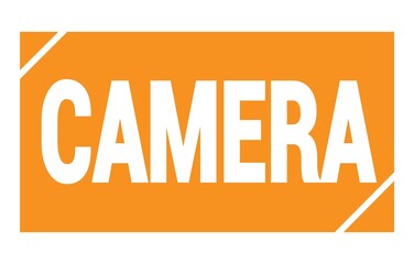 CAMERA text written on orange stamp sign.