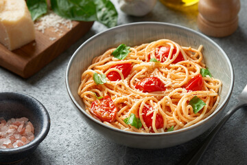 Spaghetti with cherry tomatoes indoors close-up from a high angle view