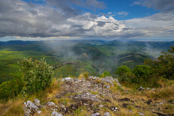 View from mountain top after rain with fog lifting up from the valley