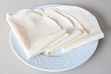 Bread, lavash ( Lavaş ) on white table.