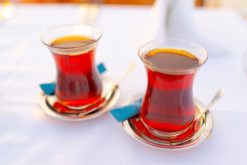 Two glasses with Turkish tea on white table