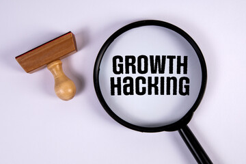 Growth hacking. Stamp and magnifying glass on white background