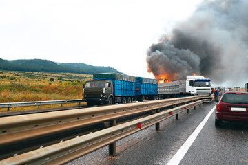 Fototapeta na wymiar Car crash accident on a highway with damaged automobiles and smoke