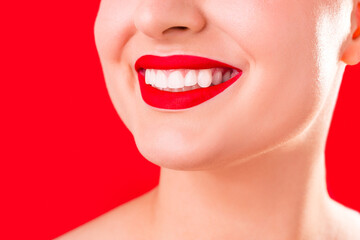 Teeth whitening. Healthy white smile close up. Beauty woman with perfect smile- lips and teeth. Beautiful Model Girl with red lips isolated on white background. Perfect skin.