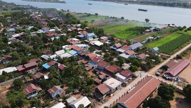 Aerial footage over a small village in a tiny island on the Mekong river, Koh Okhna Tey, few kilometers from Phnom Penh city, Capital of Cambodia  1-2