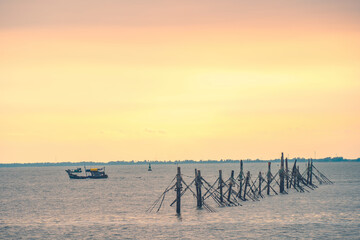 Tropical Seascape with a boat on sandy beach at cloudy sunrise or sunset. Beautiful sunset tropical beach with small boat and pink sky for travel and vacation in holiday relax time. Vung tau city.