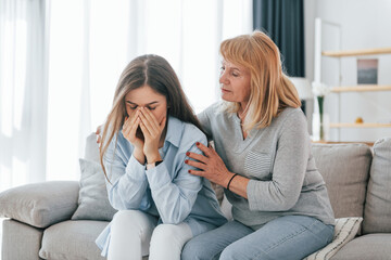 Woman supports her daughter. Mother and woman is together at home