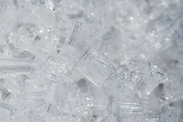 Transparent frozen small ice pieces. Abstract full frame background. 