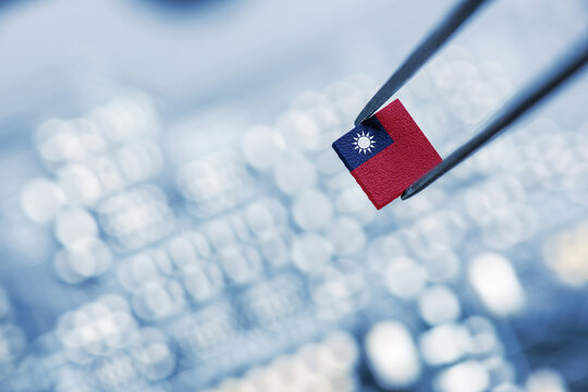 Flag of the Republic of China or Taiwan on a processor, CPU Central processing Unit or GPU microchip on a motherboard. Taiwan manufacturing chip industry emerges as battlefront in US - China showdown.