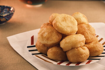 Freshly baked Boortsog (baursak) Traditional Kazakh Asian food in the sunrise at Kazakh home