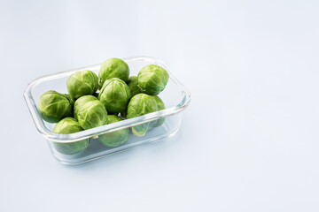 Glass box with fresh brussels sprouts.  Vegetables in a glass containers. Food storage concept